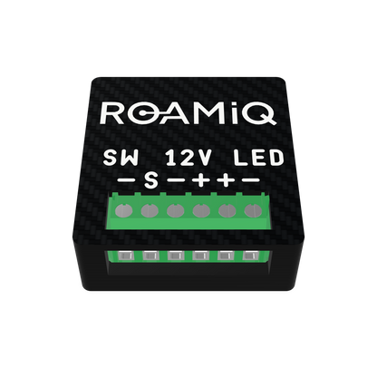 ROAMiQ 12A DC Dimmer chip, front view, with labeled green screw terminals